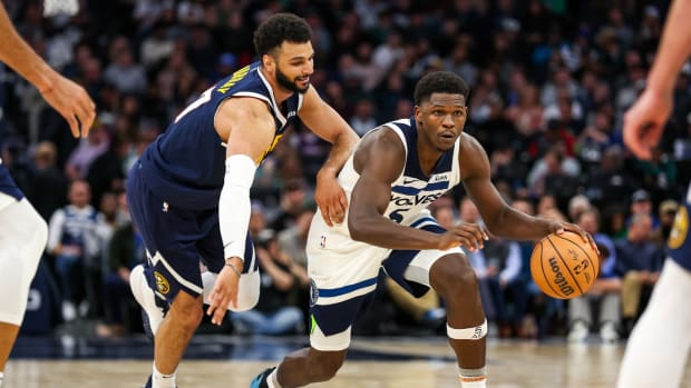 Nov 1, 2023; Minneapolis, Minnesota, USA; Minnesota Timberwolves guard Anthony Edwards (5) drives while Denver Nuggets guard Jamal Murray (27) defends during the second half at Target Center.